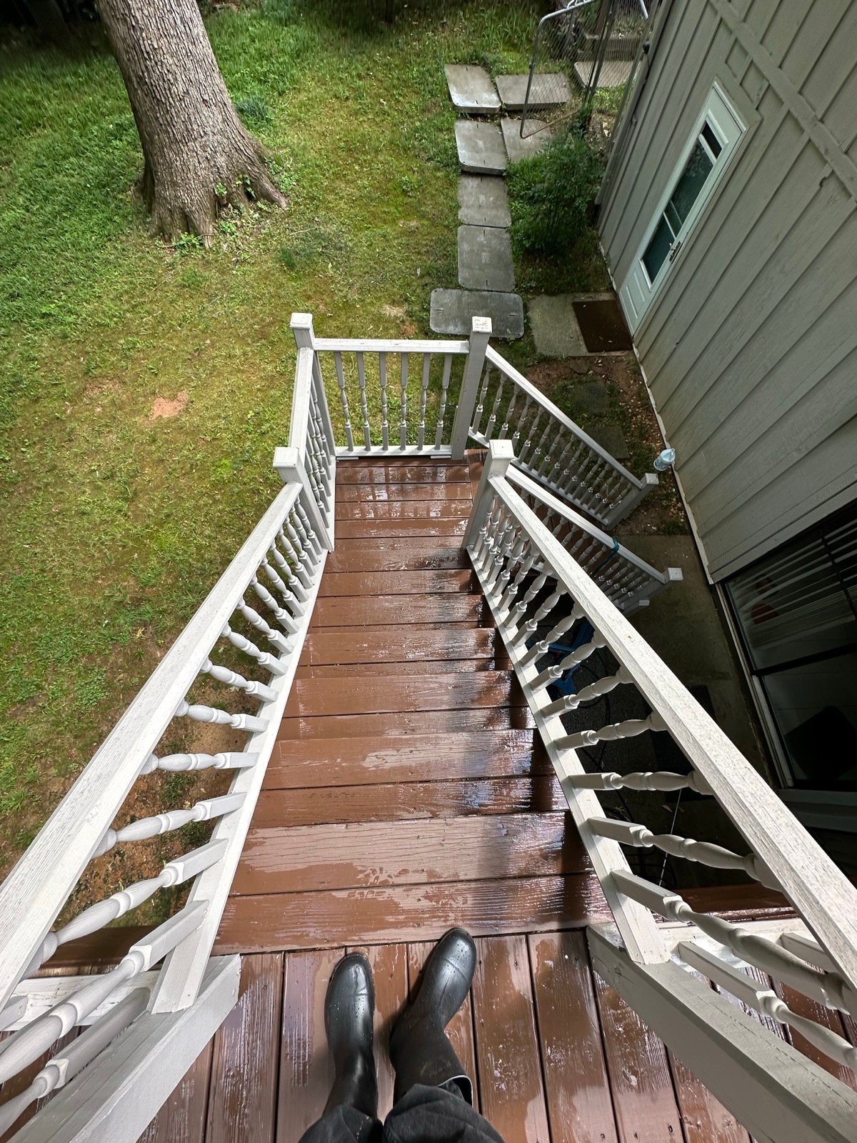 Deck stairs and railing after cleaning, restored wood tone